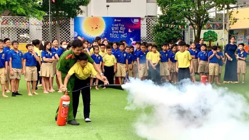 Cán bộ Cảnh sát PCCC và CNCH hướng dẫn học sinh sử dụng bình chữa cháy cầm tay dập tắt đám cháy