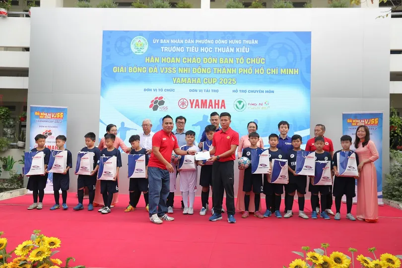 Đại diện Ban tổ chức giải và nhà tài trợ trao quà đến các em học sinh.