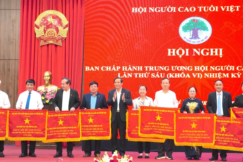 Ông Nguyễn Thanh Bình, Chủ tịch Hội Người cao tuổi Việt Nam trao cờ thi đua cho các tập thể. QUANG HUY