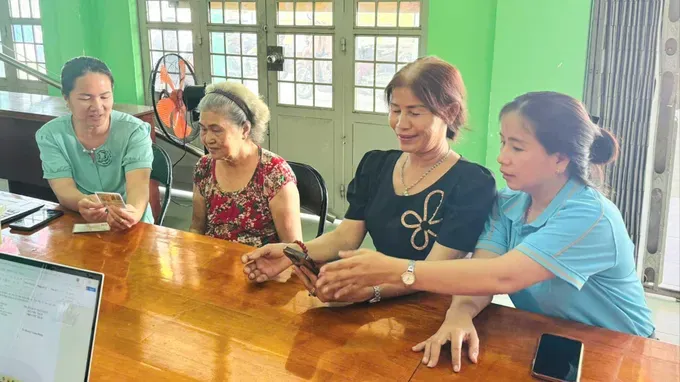 A dedicated specialist from the Thai My Public Administration Service Center is passionately advising a resident on online procedures in Binh Ha Dong hamlet (Photo: SGGP)