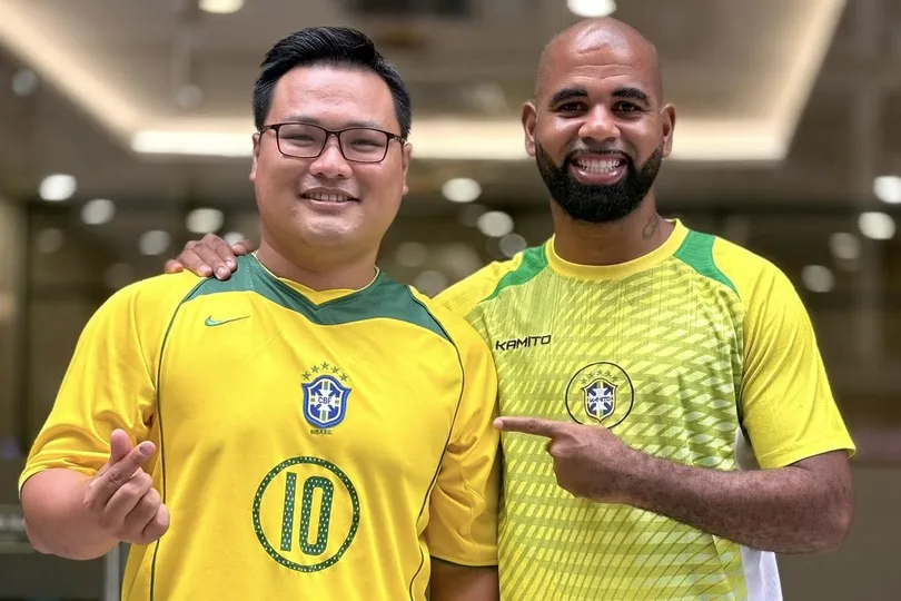 Cựu Vua phá lưới V-League Claudecir Junior (phải) cùng một người hâm mộ Việt Nam yêu mến Brazil. ẢNH: TÂM HÀ 