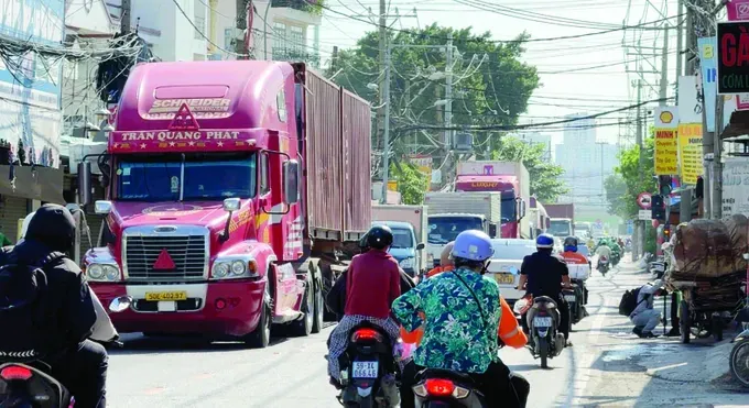 A large number of container trucks travel along Nguyen Duy Trinh Street en route to Tan Cang–Cat Lai Port in Ho Chi Minh City. (Photo: SGGP)
