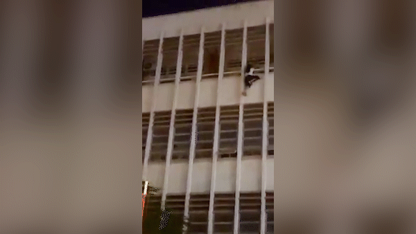 Security guard saves female student hanging from balcony