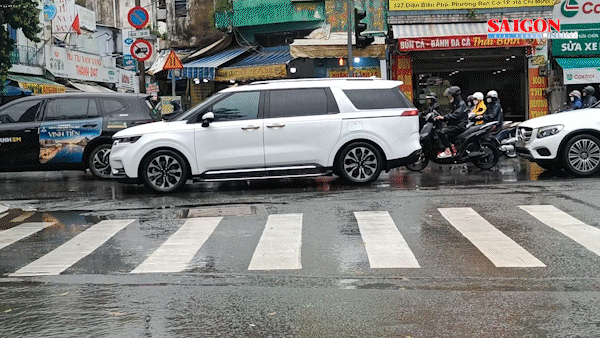 Người dân TPHCM vất vả đi làm trong cơn mưa lớn sáng 23-9