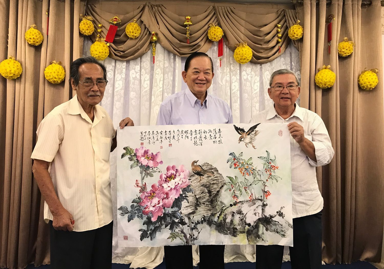 (左起)书画家李松年,吴广沛和 黄献平合绘的画作.