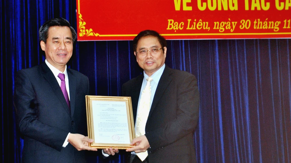 Đồng chí Phạm Minh Chính (phải) trao quyết định của Bộ Chính trị cho đồng chí Nguyễn Quang Dương 
