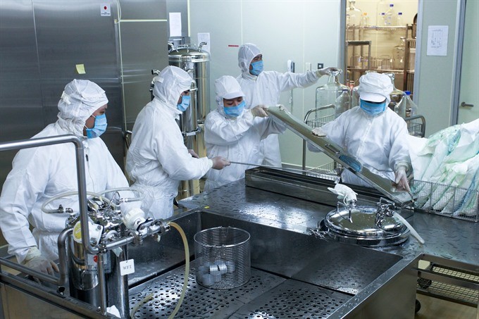 POLYVAC staff work on producing a measles-rubella vaccine. — Photo courtesy of Japan International Co-operation Agency
