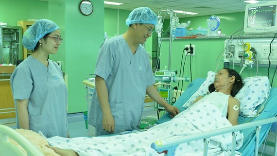Medical workers talk to the patient after the operation (Photo: SGGP)