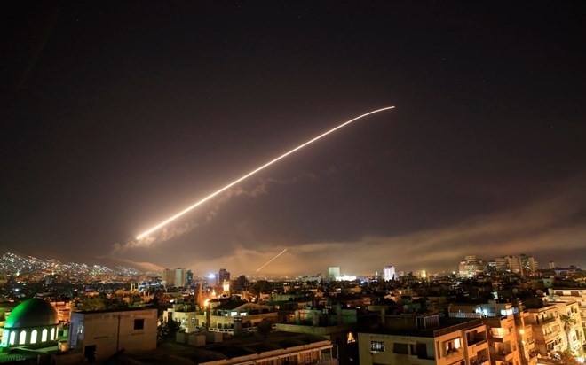 Syria's Damascus sky lights up with service to air missile fire (Photo: AP)