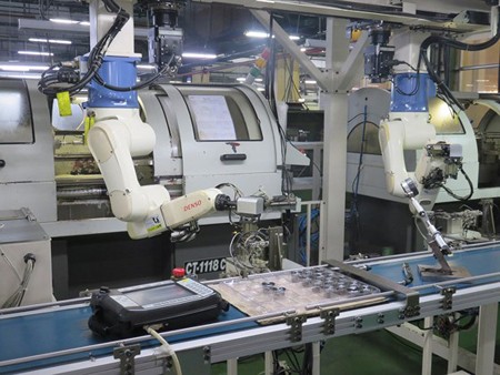 Robot hands in the assembly line of a manufacturing plant of Juki Company