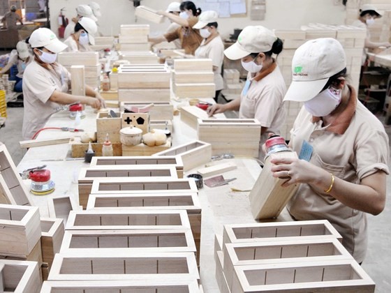 Workers are processing wooden products for export (photo: SGGP)