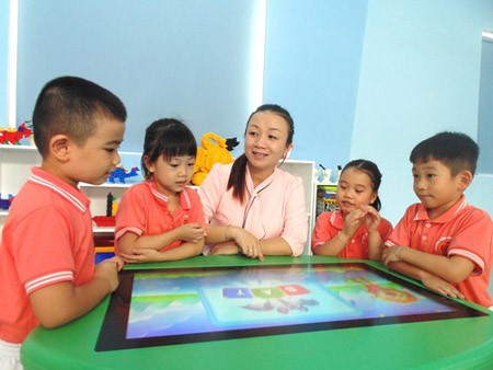 A teacher and her pupils learning with an interactive board in Mang Non 1 Kindergarten (District 10)