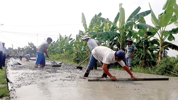 Asphalted roads are built in Long An to replace mud ones (Photo: SGGP)