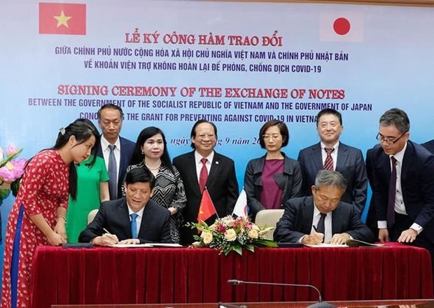 Acting Minister of Health Nguyen Thanh Long (L) and Japanese Ambassador Yamada Takio sign the exchange note in Hanoi on September 7 (Photo: VNA)