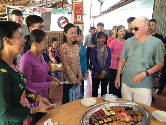 British billionaire Joe Lewis enjoys traditional cakes made by artisans in Con Son islet.