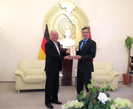 Head of the Propaganda Department of the City Party Committee Phan Nguyen Nhu Khue offers a souvenir to Vietnamese Ambassador to Germany Nguyen Minh Vu 