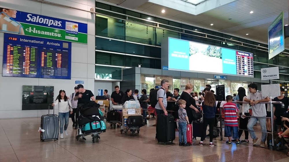 Passengers queuing to get checked in at Tan Son Nhat airport 