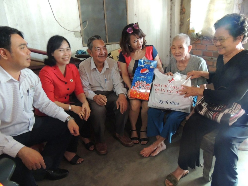 守德郡紅十字會主席鄧陳源草(左二)與熱心人士探望94高齡孤寡老人阮氏儒(右二)。