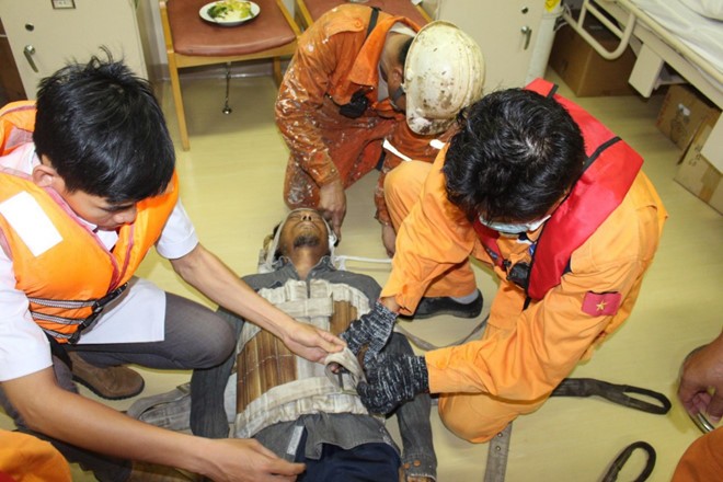 救援力量及時進行各項急救措施，從速把Kuang Myat Zaw送回芽莊港治療。（圖源：阮鐘）