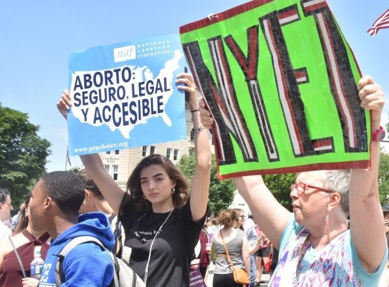 抗議者舉著寫有“保護安全、合法墮胎”、“我的身體我做主”、“墮胎是人權”等標語的牌子，高喊“解除禁令”。（圖源：互聯網）