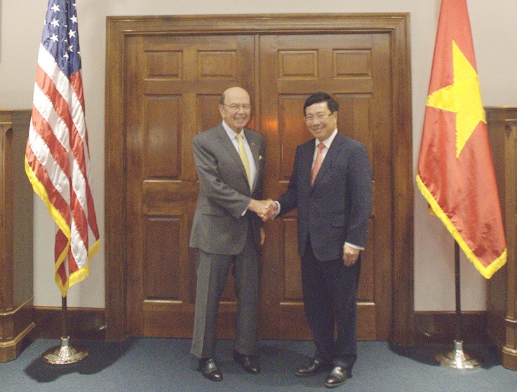 政府副總理、外交部長范平明（右）與美國商務部長威爾伯‧羅斯舉行會談。（圖源：VOV）