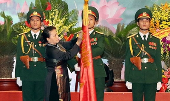 國會主席阮氏金銀向在抗美戰爭幫助老撾革命並取得特別出色成績的越南志願軍和專家頒授人民武裝力量英雄稱號。（圖源：越通社）