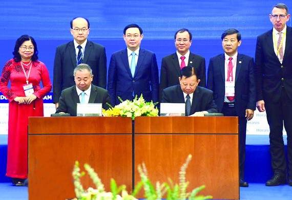 王廷惠副總理（後排左三）與平陽省領導見證 Becamex IDC 集團與合作夥伴簽署合作儀式。（圖源：VGP）