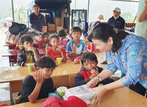 《西貢解放報》副總編輯李越中向廣義省茶林小學生贈送書本。