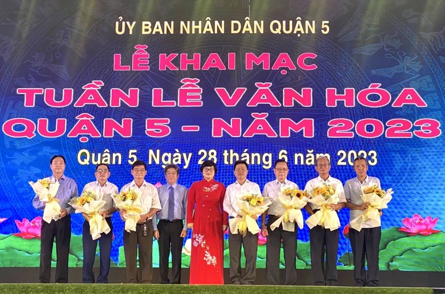 第五郡人委会主席张明娇（左五）、副主席阮武春奇（左四）向7华人会馆赠送鲜花感谢赞助《自豪第五郡文化遗产》一书再版经费。