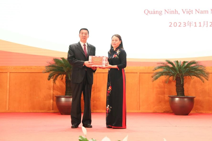 越南祖国阵线中央委员会副主席阮氏秋霞向中国政协副主席王勇赠送礼物。