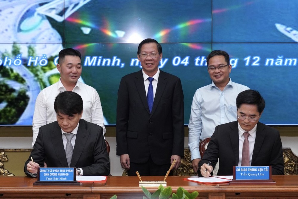 市人委会主席潘文迈（中）见证双方签署跨越西贡河步行桥架设项目赞助协议。（图：玄英）