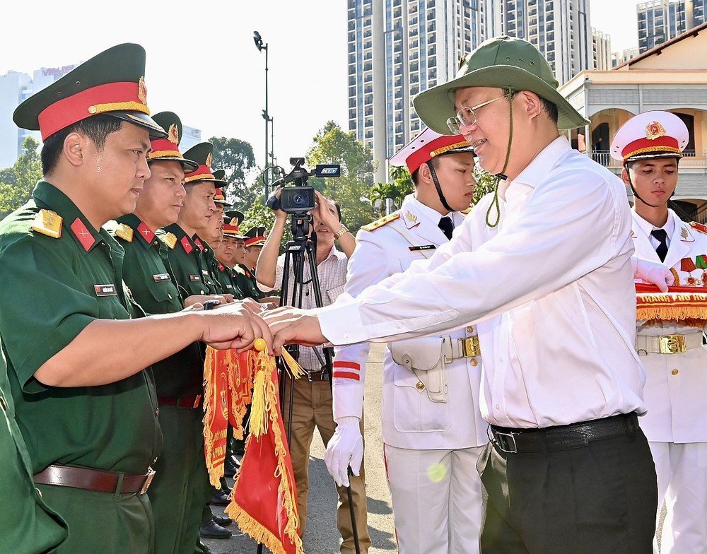 市委常务副书记阮胡海向参加单位颁授纪念旗帜。（图：越勇）