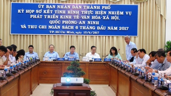  A view of the meeting chaired by HCMC chairman Nguyen Thanh Phong to review economic, social and cultural conditions in the first half this year on June 14 (Photo: SGGP)
