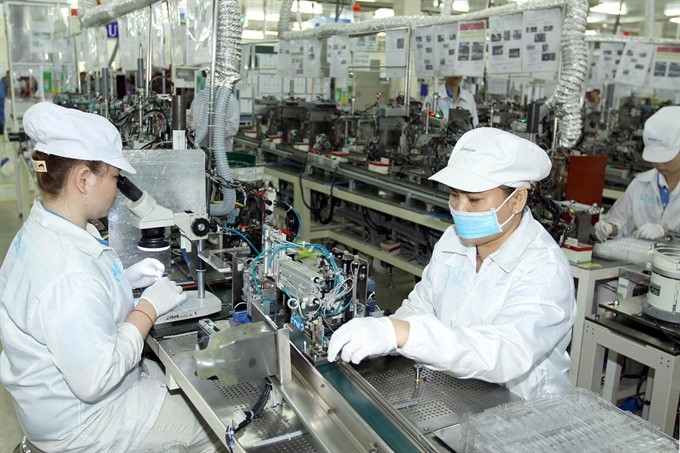 Manufacturing electronic components at the Japan-based Nidec Sankyo Ltd Co in the Saigon Hi-tech Park in HCM City. (Photo: VNA/VNS)
