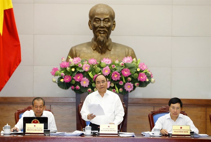 Prime Minister Nguyen Xuan Phuc delivers a speech at the Government’s regular meeting reviewing socio-economic, defence, security and diplomatic conditions of the country in the first half of this year on Monday morning. (Photo: VNA/VNS)