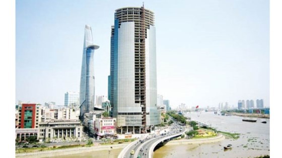 Saigon One Tower (R) at 34 Ton Duc Thang has been half done since 2011 (Photo: SGGP)