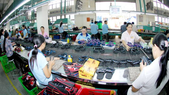 Workers making footwear products for export (Photo: SGGP)