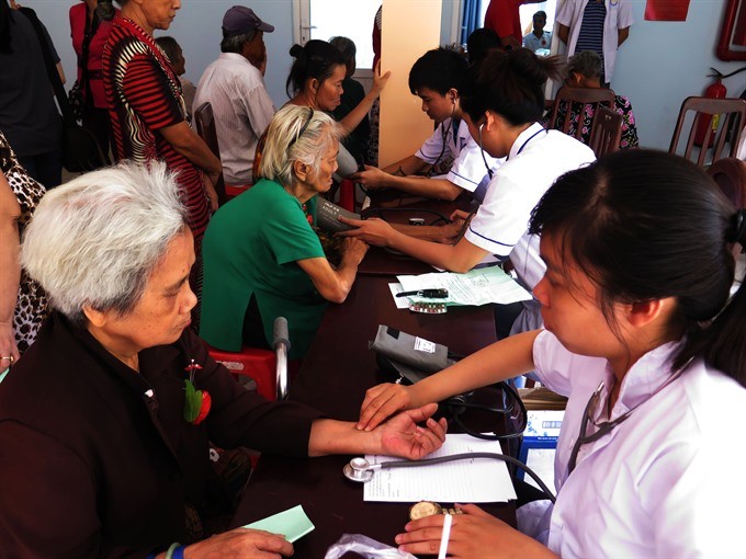 Senior citizens receive health checks in District 8, HCM City. (Photo: VNA/VNS)