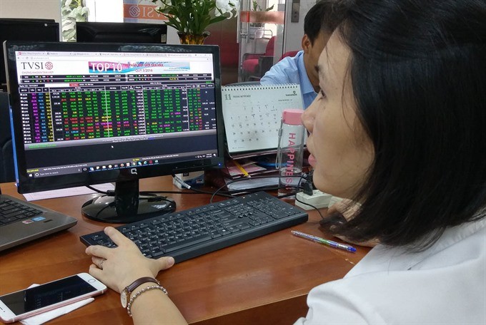 An investor watches share prices at Tân Việt Securities Company. (Photo: VNS)