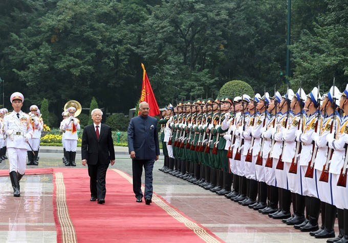 Party General Secretary, President Nguyen Phu Trong (left) and Indian President Ram Nath Kovind review a guard of honour in Hanoi yesterday. (Photo: VNA/VNS)