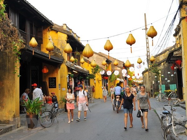 Visitors on a street in Hoi An ancient town (Photo: VNA)