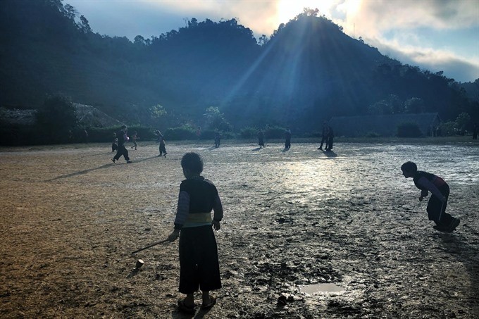 Children play a folk fame football in Huatat Village