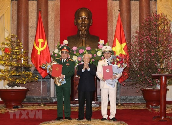 Party General Secretary and President Nguyen Phu Trong, who is also Secretary of the Central Military Commission and Chairman of the National Defence and Security Council, hands over the promotion decisions to the officers during a ceremony in Hanoi yeste