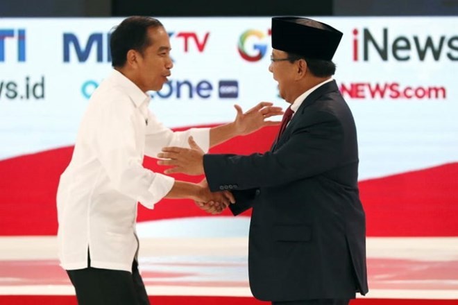 Presidential candidates Joko Widodo (left) and Prabowo Subianto shake hands during a debate among candidates in Jakarta, Indonesia, on Feb 17, 2019. (Source: EPA-EFE)