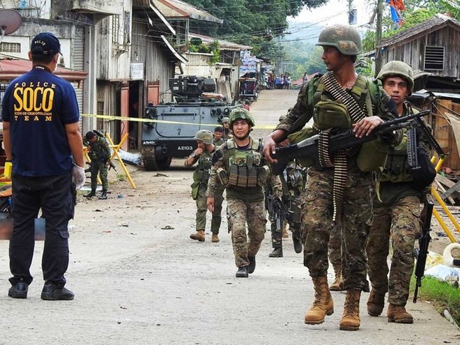The Crime Operatives (SOCO) police and the Explosive Ordnance Disposal (EOD) members conduct an investigation after a blast in the temporary Camp of 1st Brigade Combat Team (1BCT) in Barangay Kajatian, Indanan, Sulu (Source: gulfnews.com)