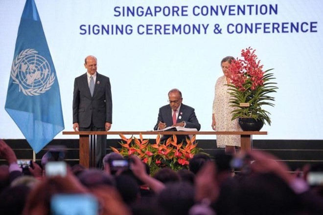 Home Affairs and Law Minister K. Shanmugam signing the Singapore Convention on Aug 7, 2019. (Source: www.straitstimes.com)