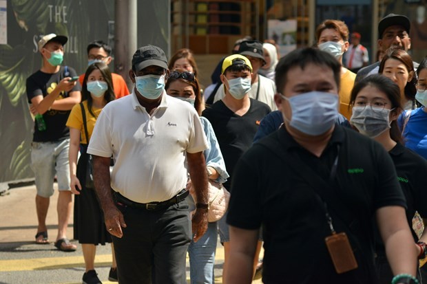 People wear face masks to avoid COVID-19 infection in Kuala Lumpur, Malaysia, on March 14 (Photo: Xinhua/VNA)