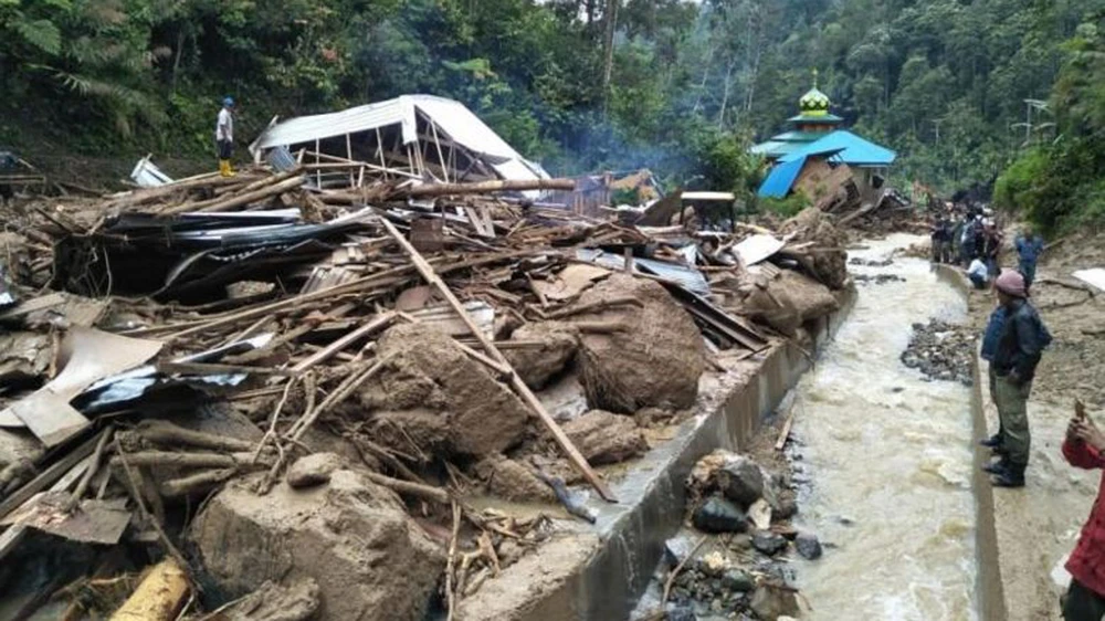Người dân kiểm tra một địa điểm sau khi bị lũ quét qua tại làng Saladi, Mandailing Natal, tỉnh Bắc Sumatra ngày 13-10