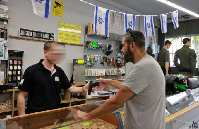 Khách hàng mua súng tại một cửa hàng ở Israel. Ảnh: Jerusalem Post