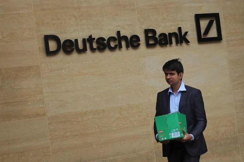 A man carrying a box leaves a Deutsche Bank office in London on Monday. PHOTO: SIMON DAWSON/REUTERS